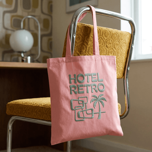 Embroidery Aftercare - a retro embroidery on a pink bag, in sage green text - Hotel Retro.