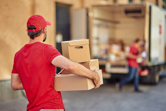Courier loading parcels into a delivery van for a fast turnaround shipment