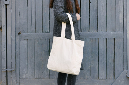 Natural cotton tote bag carried over the shoulder as an everyday handbag