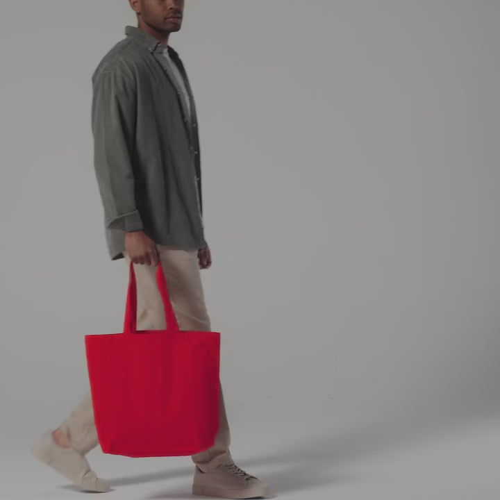 Video of a red organic cotton maxi tote with gusset, carried by hand